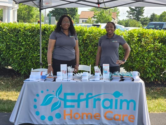 Staff members at an outdoor information booth
