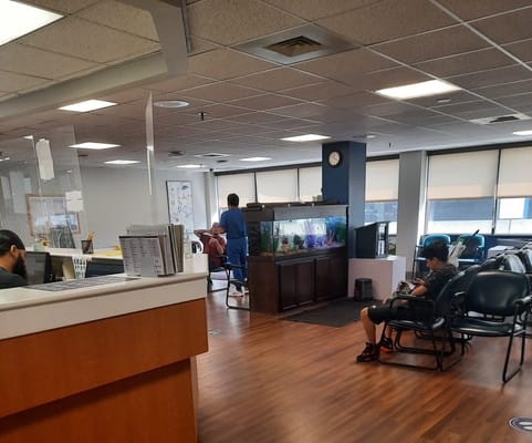 Interior view of a common area with residents and an aquarium