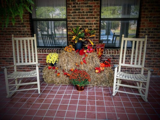 Decorative fall-themed arrangement with rocking chairs