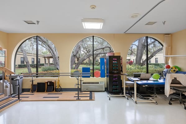 Rehabilitation room with exercise equipment and large windows
