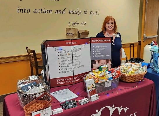 Staff member at a care services information table