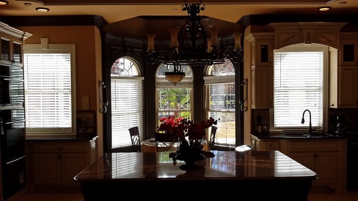 Bright kitchen with elegant windows and dining area