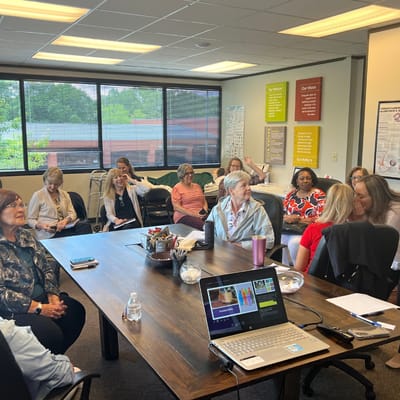 Residents and staff engaged in a meeting in a common area