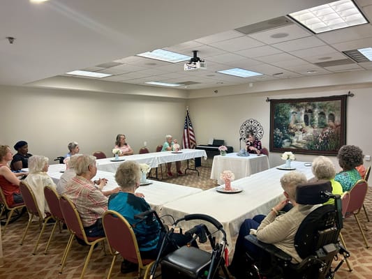 Residents participating in a group discussion in a meeting room