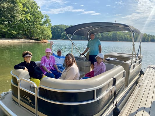 Group of seniors on a boat by the water