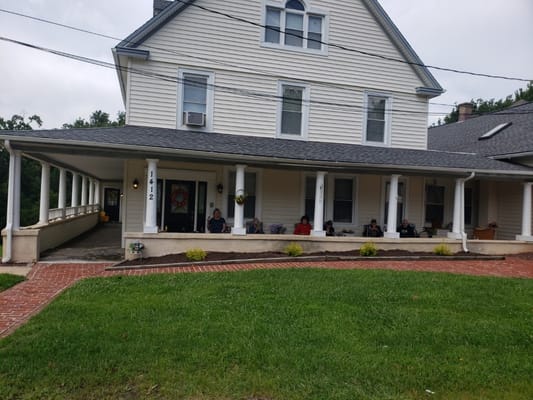 Residents enjoying the porch of the facility.