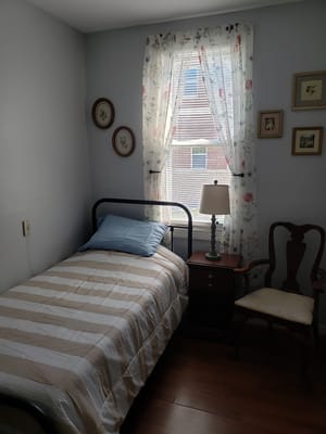 Cozy private resident room with a bed and lamp