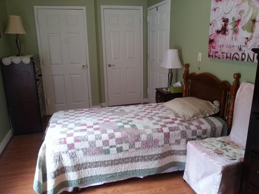 Cozy resident room with a quilted bedspread and lamps