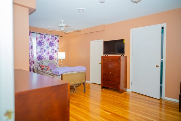 Cozy resident room with wooden furniture and light decor