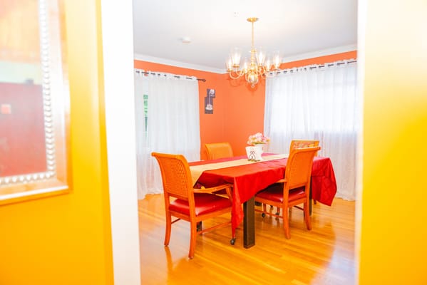 Brightly lit dining area with a red tablecloth