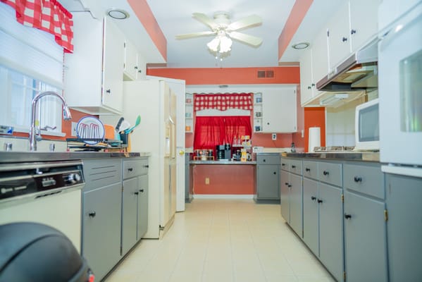 View of a kitchen with cabinets and appliances
