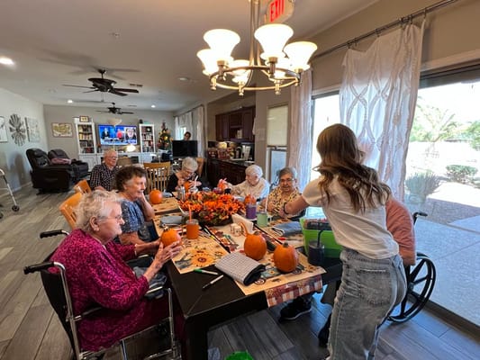 Residents participating in a pumpkin painting activity