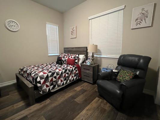 Cozy resident room with a bed and chair