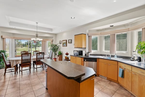 Bright kitchen area with dining table and large windows