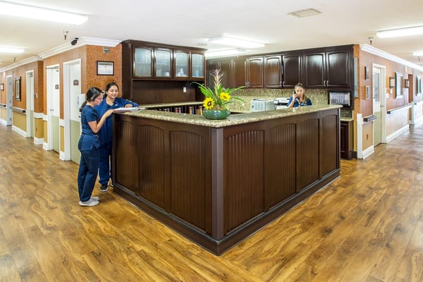 Staff interacting at the reception in a bright lobby