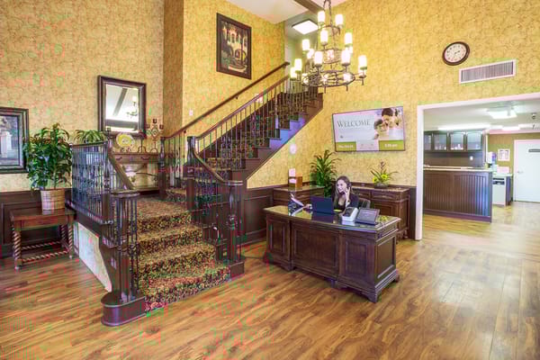 Reception area with a staircase and plants
