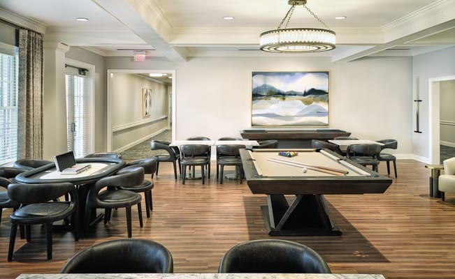 Interior view of the game room featuring a billiards table and dining tables.