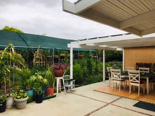 Outdoor patio area with tables and plants