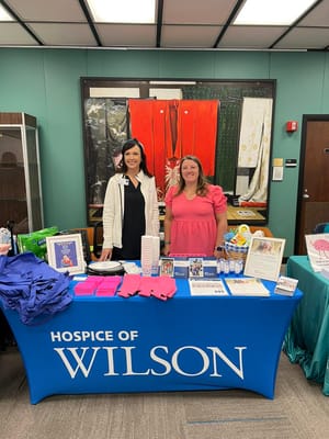 Staff members at a table with promotional materials