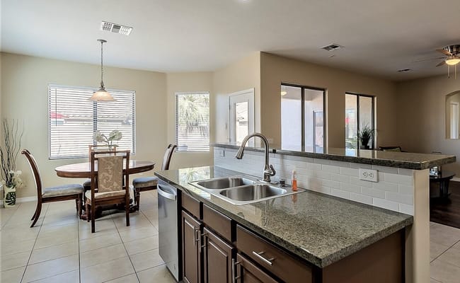 Modern kitchen with dining table and chairs.
