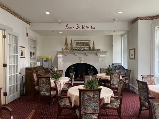 Seating area with decorated fireplace and tables