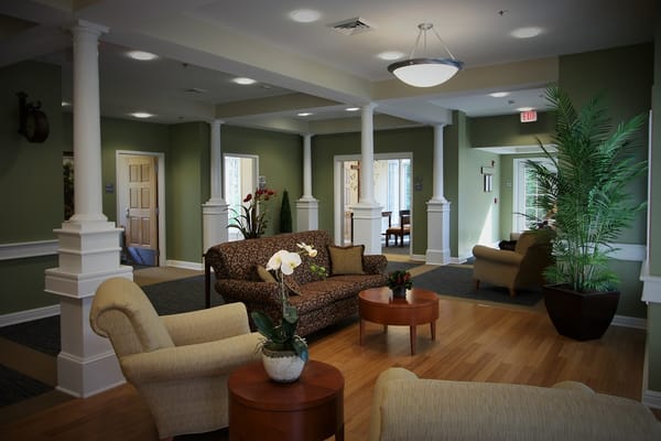 Bright common area with seating and plants.