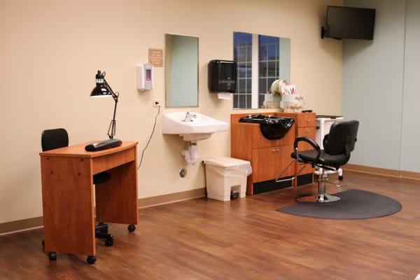 Hair salon area with styling chair and sink