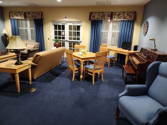 Common area in a senior living facility with seating and tables