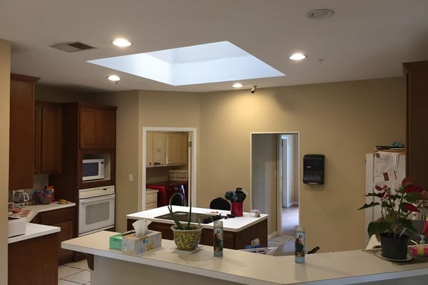 Bright kitchen with wooden cabinets and skylight