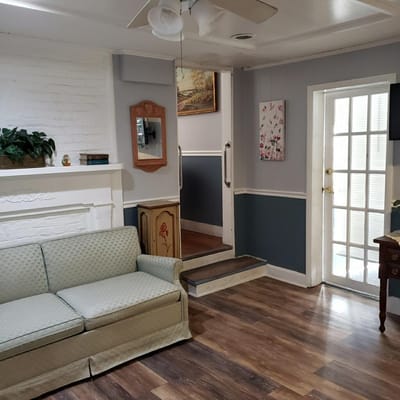 Living room with a sofa, fireplace, and door to outside