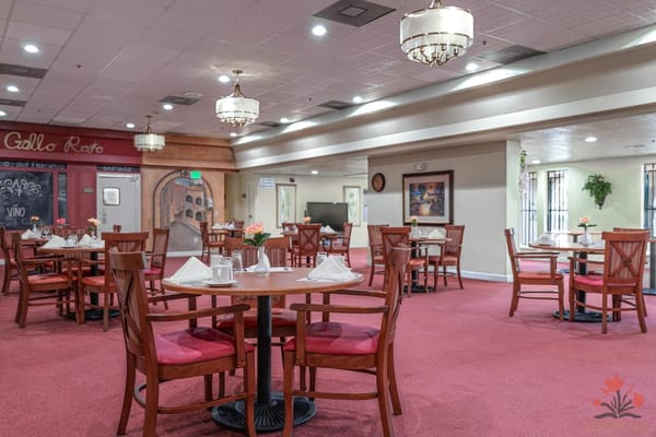 Interior view of the dining room with tables set for meals
