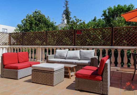 Cozy outdoor lounge with gray and red seating