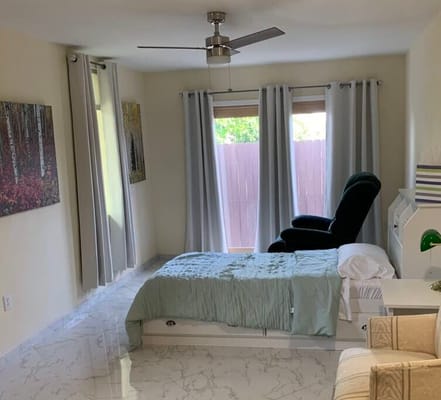 Cozy resident room with bed and chair