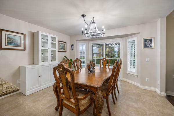 Dining area with a large wooden table and chairs