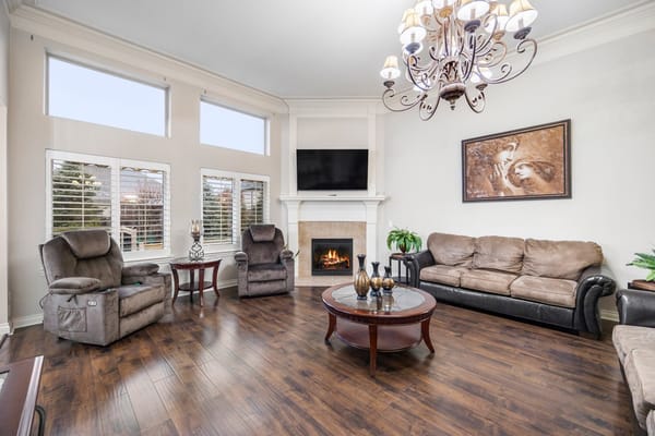 Bright common area with comfortable seating and a fireplace