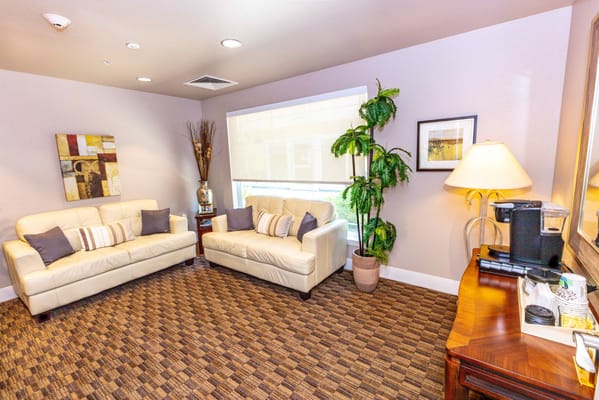 Bright interior lounge area with couches and decor