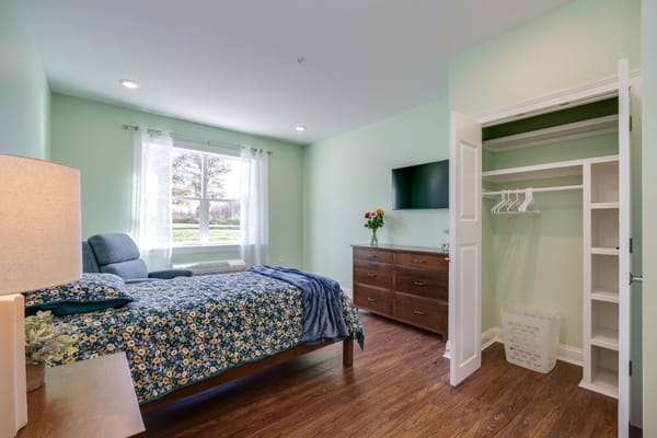 Cozy bedroom with floral bedding and a view outside