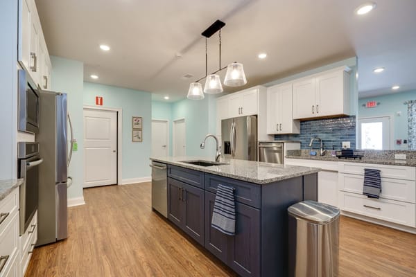 Bright kitchen with granite countertops and modern appliances.