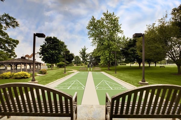 Outdoor shuffleboard court with benches at Normandy Farms Estates