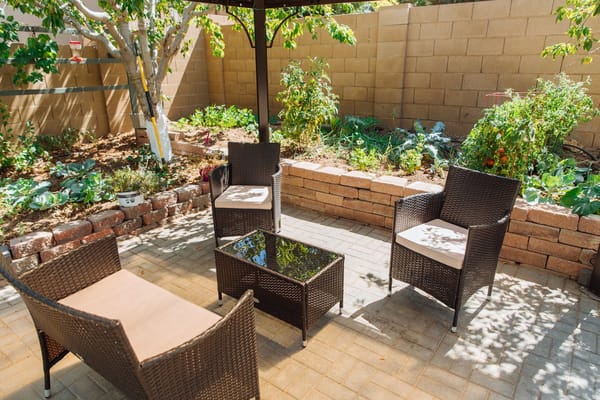 Outdoor seating area with chairs and a table in a garden