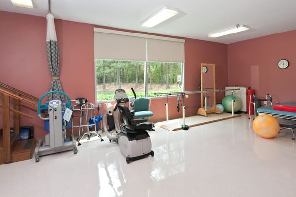 A therapy room featuring various exercise equipment and therapy aids.