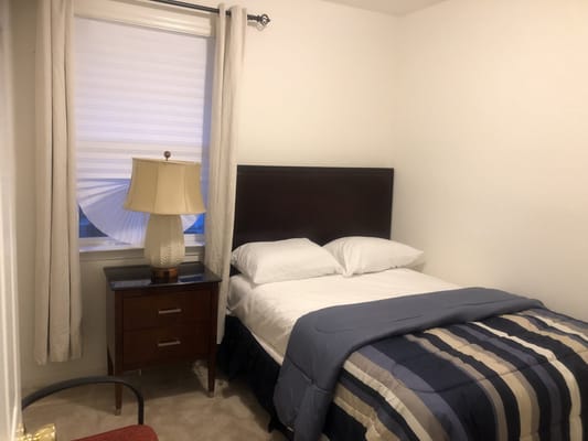 Cozy resident room with a bed and nightstand