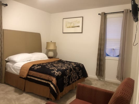 Cozy private resident room with a bed and chair