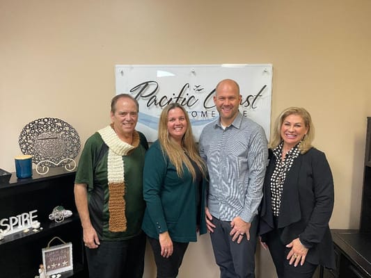 Staff members posing in the facility office.