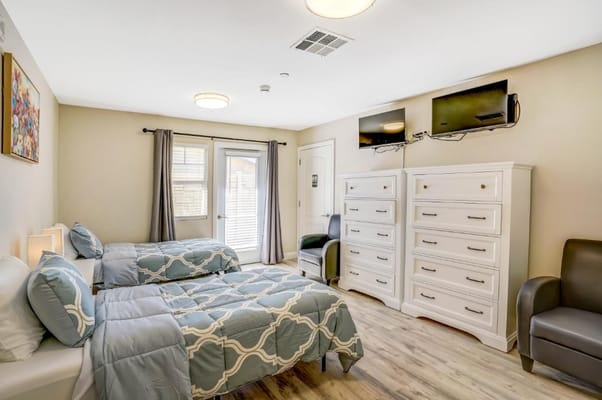 Brightly furnished shared resident room with two beds