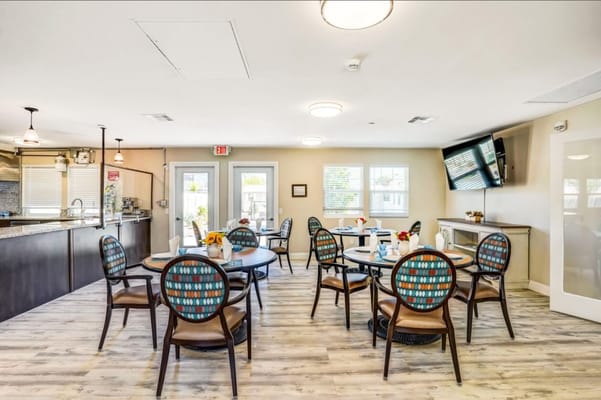 Bright dining area with tables and chairs arranged.