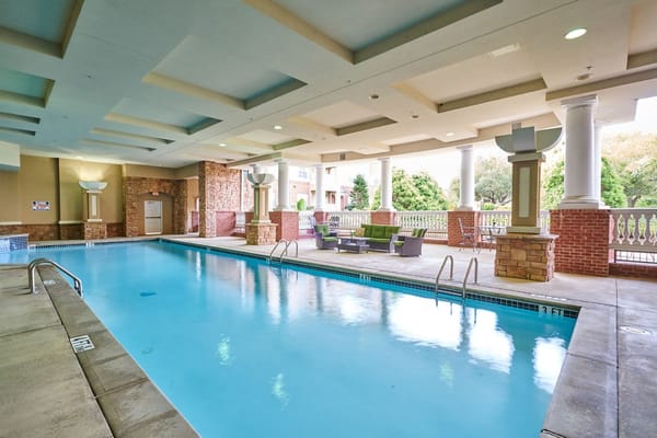 Indoor swimming pool area with lounge seating