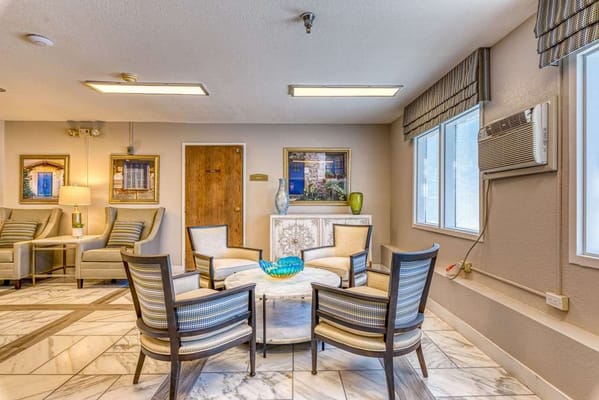Common area with seating and decor in a senior living facility