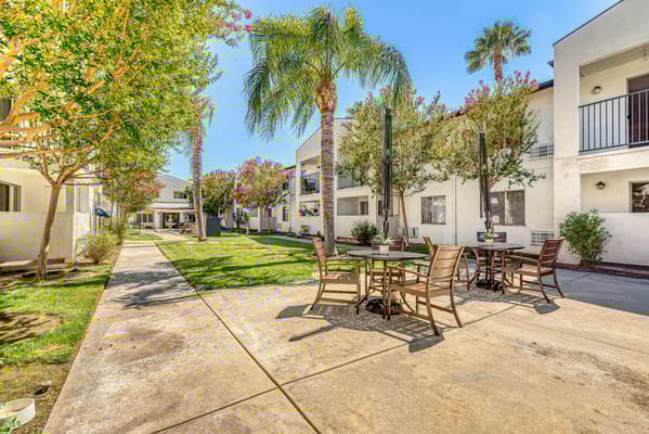 Outdoor space with seating and landscaping at Parkside Senior Apartments