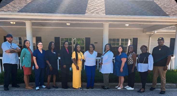 Staff members posing outside the facility